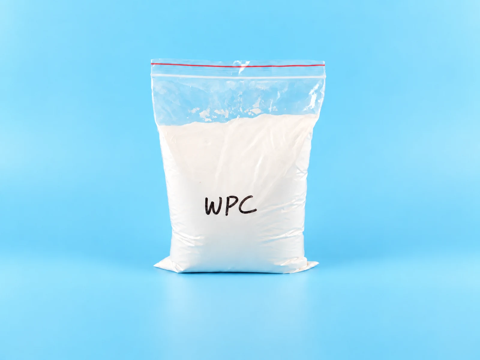 White powder compatibilizer sample in a laboratory dish